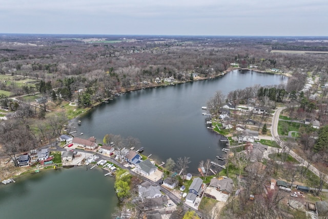 birds eye view of property with a water view and a forest view