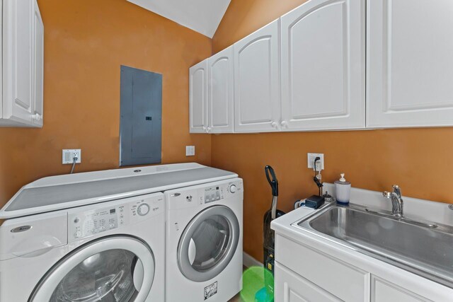 washroom featuring a sink, washer and dryer, electric panel, and cabinet space