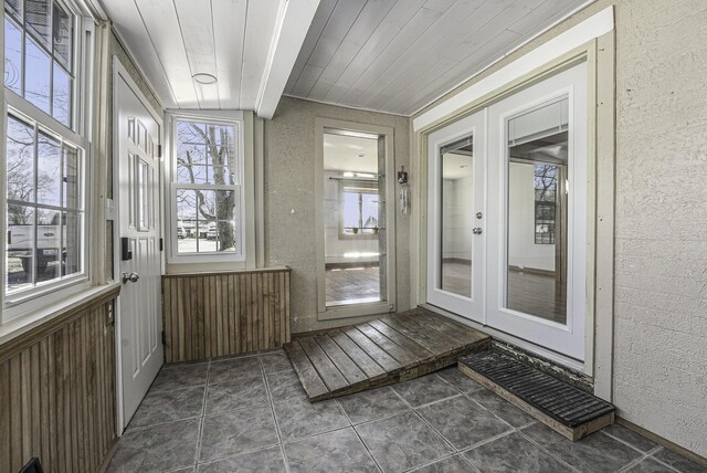 unfurnished sunroom with french doors