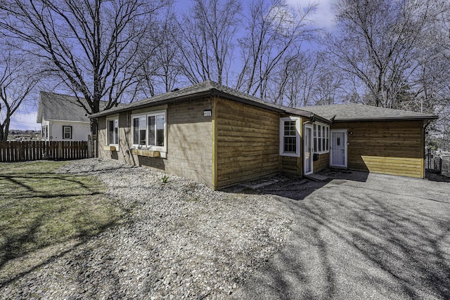 back of house featuring fence