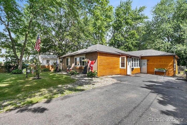 view of home's exterior featuring a lawn and fence