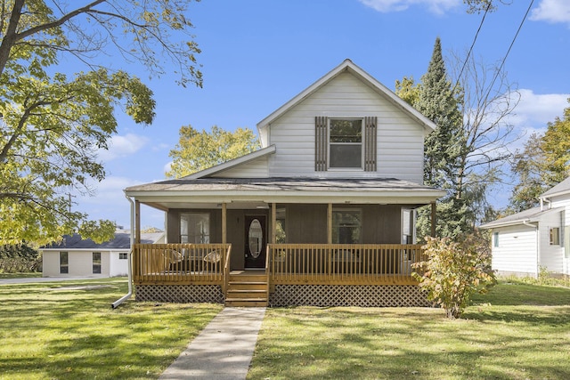 65 N Lake St, Grant, MI 49327 - view of front facade featuring a front lawn and covered porch