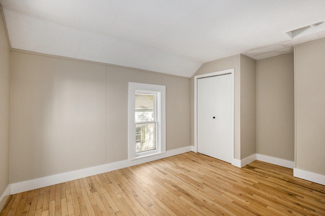 65 N Lake St, Grant, MI 49327 - interior space featuring vaulted ceiling, visible vents, baseboards, and light wood-style flooring