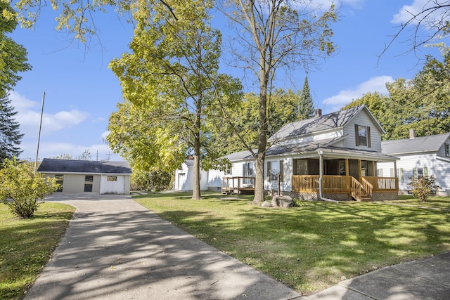 65 N Lake St, Grant, MI 49327 - farmhouse inspired home with covered porch, a front lawn, aphalt driveway, and a chimney