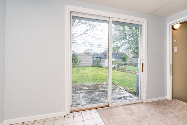 doorway to outside featuring a healthy amount of sunlight and baseboards