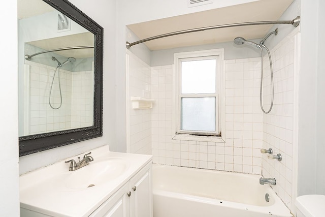 bathroom featuring shower / bath combination, vanity, toilet, and visible vents
