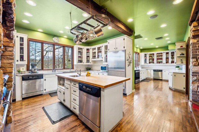 2801 Niles Buchanan Rd, Buchanan, MI 49107 - kitchen featuring wood counters, light wood-type flooring, white cabinetry, backsplash, and appliances with stainless steel finishes