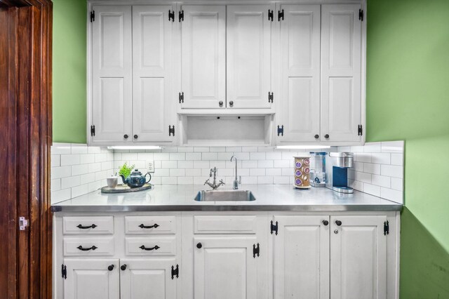 2801 Niles Buchanan Rd, Buchanan, MI 49107 - kitchen with decorative backsplash, white cabinetry, a sink, and light countertops