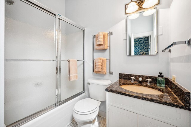2801 Niles Buchanan Rd, Buchanan, MI 49107 - bathroom with combined bath / shower with glass door, toilet, and vanity