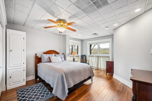 2801 Niles Buchanan Rd, Buchanan, MI 49107 - bedroom with visible vents, wood finished floors, baseboards, and a drop ceiling