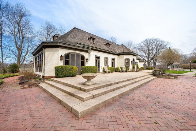 2801 Niles Buchanan Rd, Buchanan, MI 49107 - exterior space featuring stucco siding and a patio