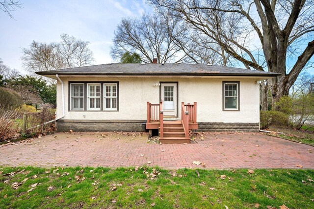 2801 Niles Buchanan Rd, Buchanan, MI 49107 - rear view of house with stucco siding and a patio area