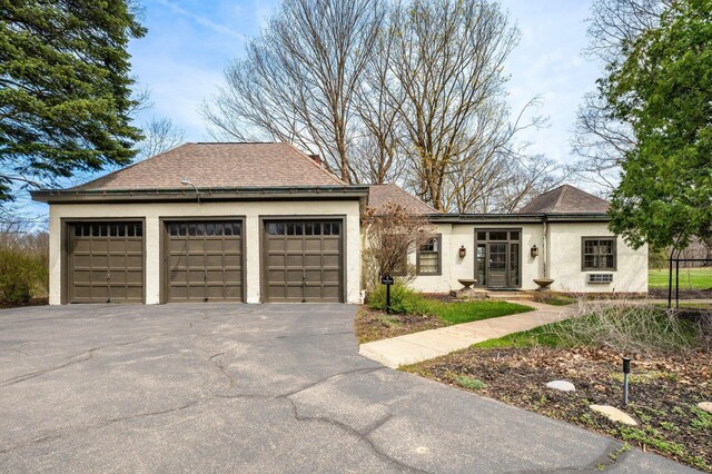 2801 Niles Buchanan Rd, Buchanan, MI 49107 - ranch-style house with a garage, roof with shingles, and stucco siding