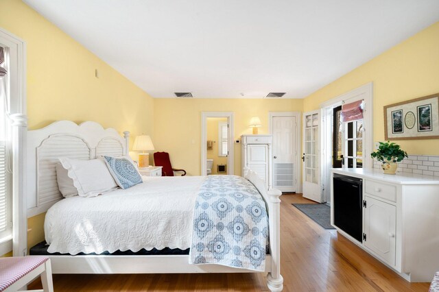 2801 Niles Buchanan Rd, Buchanan, MI 49107 - bedroom featuring light wood-style floors, visible vents, refrigerator, and ensuite bathroom