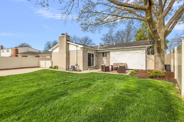 rear view of property with a patio, brick siding, an outdoor living space, a fenced backyard, and a chimney
