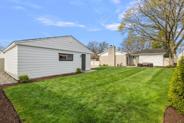 view of yard featuring outdoor lounge area and fence