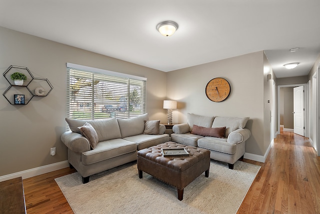 living area with wood finished floors and baseboards