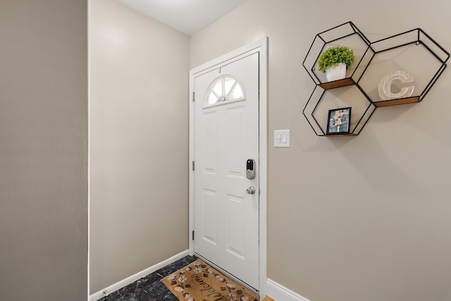 doorway to outside featuring baseboards