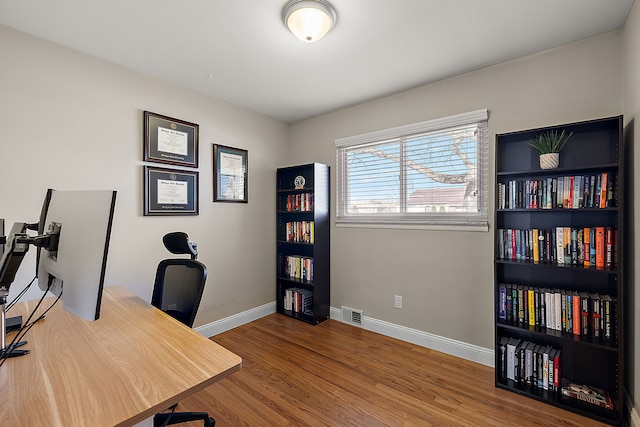 office featuring visible vents, wood finished floors, and baseboards