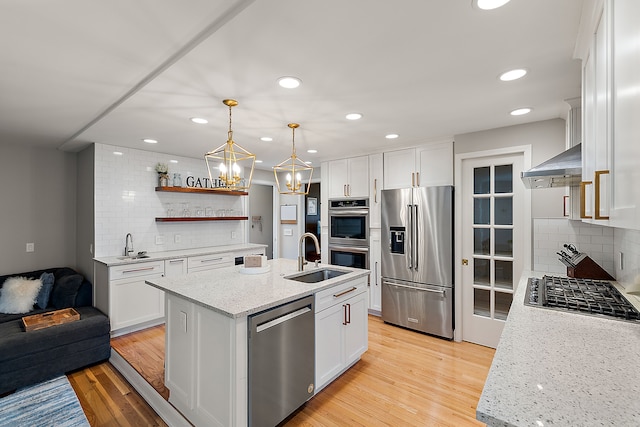 kitchen with white cabinetry, tasteful backsplash, appliances with stainless steel finishes, and a sink