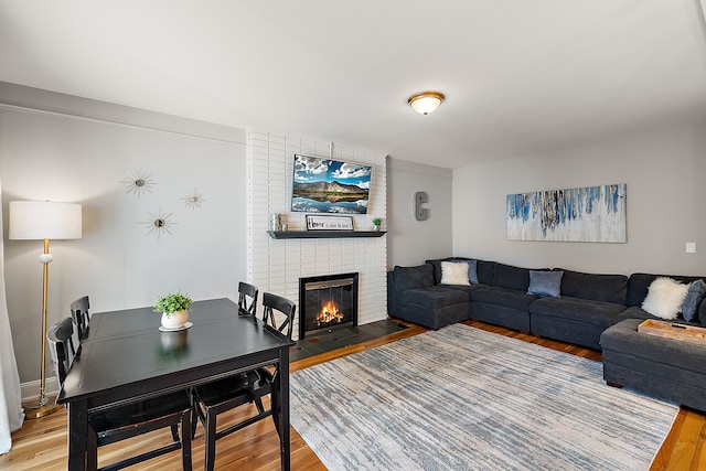 living area featuring wood finished floors and a fireplace