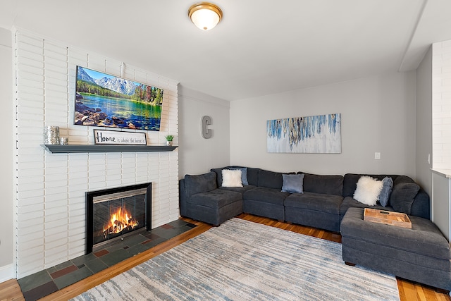 living area with a fireplace and wood finished floors