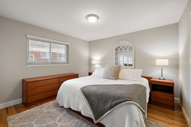 bedroom featuring wood finished floors and baseboards