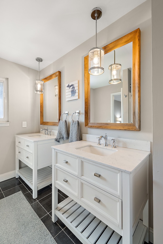 bathroom featuring tile patterned floors, two vanities, and a sink