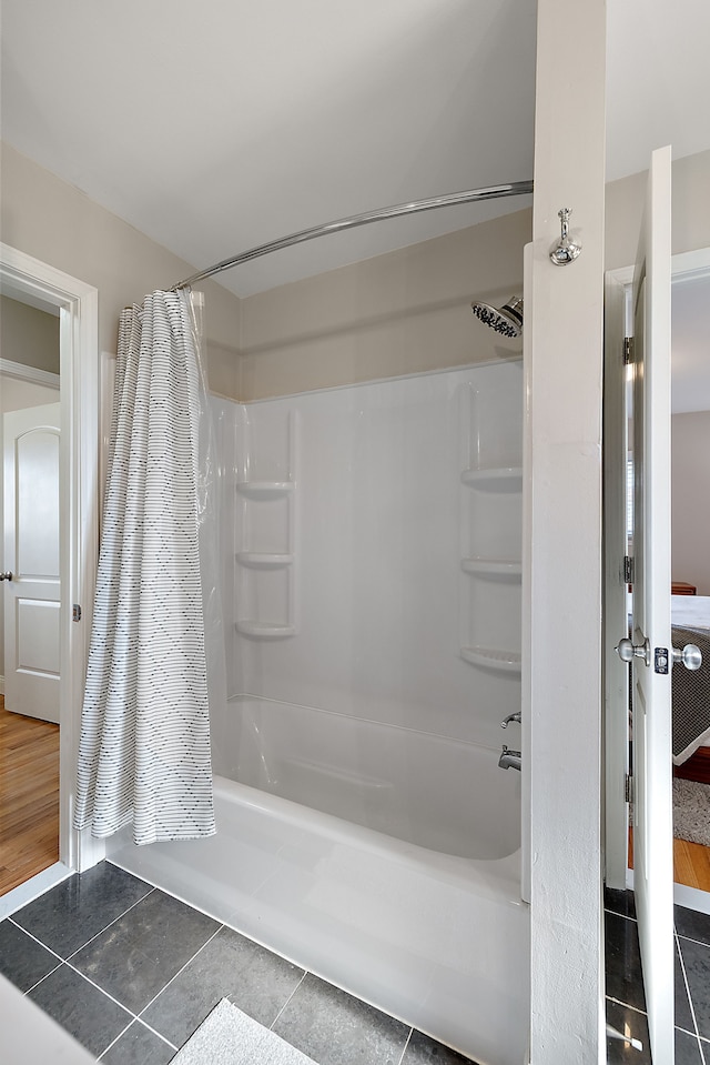 full bath featuring tile patterned flooring and shower / tub combo with curtain