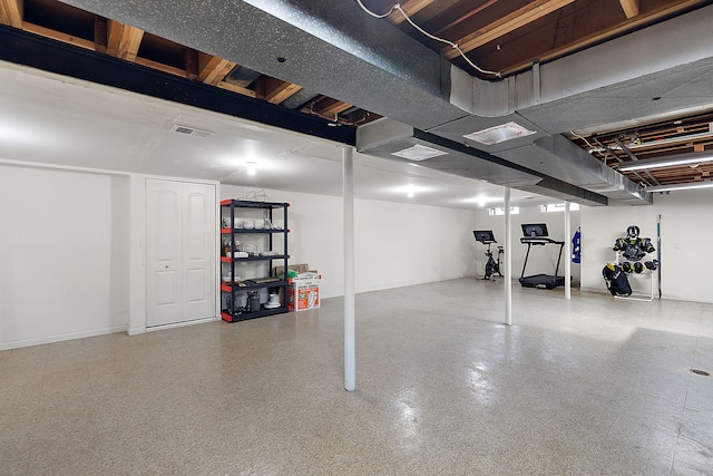 basement featuring baseboards and visible vents