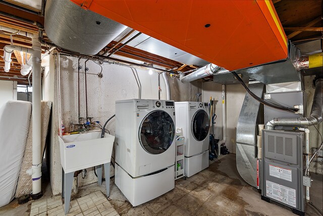 washroom with washer and dryer, heating unit, and laundry area