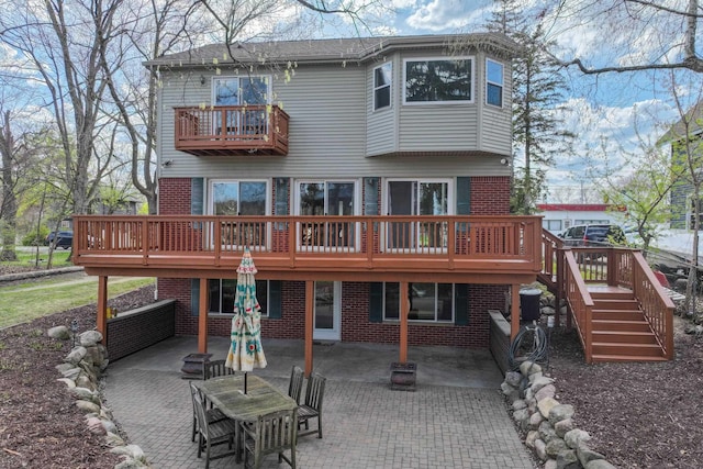 16191 Seymour Rd, Argentine, MI 48451 - back of house with brick siding, a patio area, a balcony, and a deck