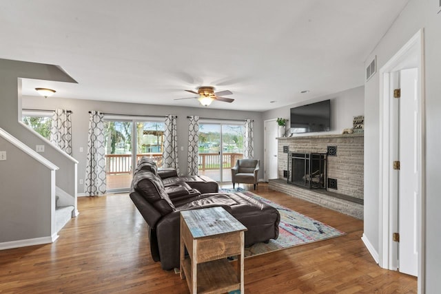 16191 Seymour Rd, Argentine, MI 48451 - living area featuring a brick fireplace, plenty of natural light, a ceiling fan, and baseboards
