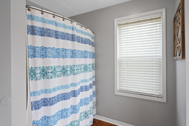 16191 Seymour Rd, Argentine, MI 48451 - full bathroom with baseboards, wood finished floors, and a shower with curtain