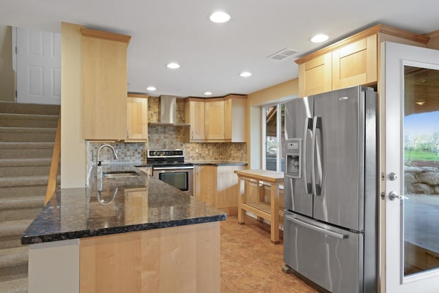 16191 Seymour Rd, Argentine, MI 48451 - kitchen featuring appliances with stainless steel finishes, wall chimney range hood, light brown cabinetry, a sink, and recessed lighting