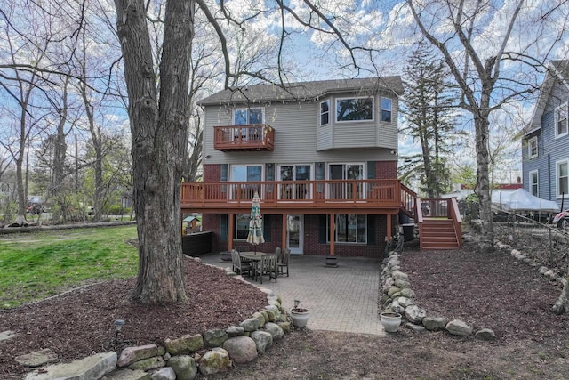 16191 Seymour Rd, Argentine, MI 48451 - back of property with a balcony, brick siding, a patio area, and stairway