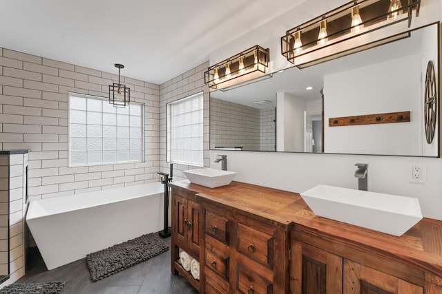 16191 Seymour Rd, Argentine, MI 48451 - bathroom featuring tile walls, a soaking tub, double vanity, and tile patterned floors