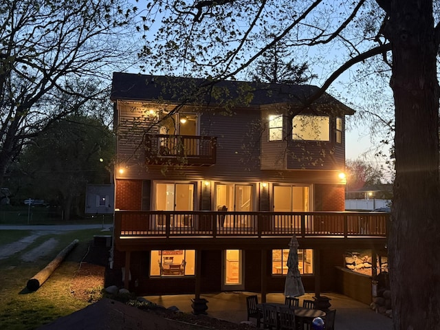 16191 Seymour Rd, Argentine, MI 48451 - rear view of house with a balcony, a patio area, and brick siding