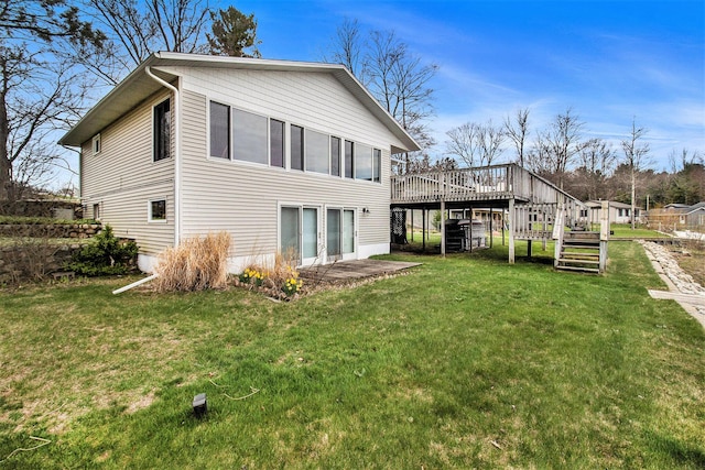 rear view of property with a lawn, a deck, and stairs