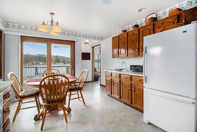 dining room featuring french doors, a toaster, baseboards, a notable chandelier, and light floors
