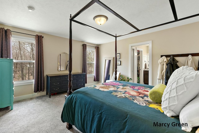 bedroom with baseboards, carpet flooring, and a textured ceiling