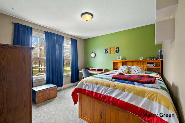 bedroom with baseboards and carpet