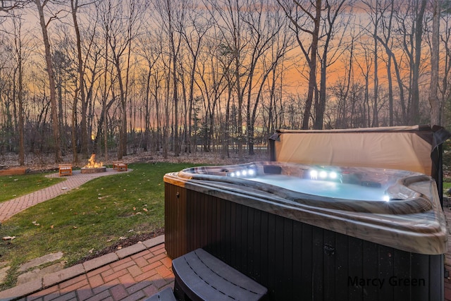 view of patio featuring an outdoor fire pit and a hot tub