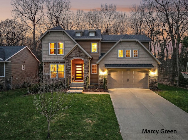craftsman-style house featuring a yard, driveway, and stone siding