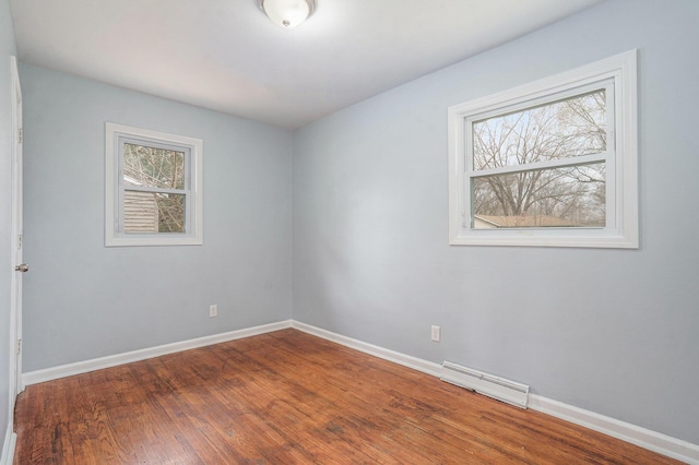 1511 Lake Ave, Portage, MI 49002 - spare room with baseboards, wood finished floors, and visible vents