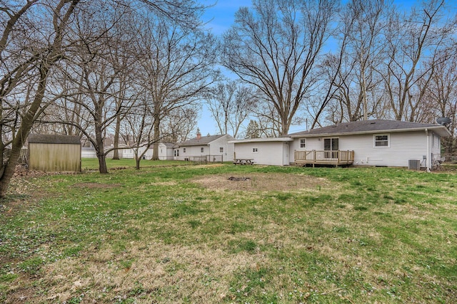 1511 Lake Ave, Portage, MI 49002 - view of yard featuring central AC, an outbuilding, a deck, and a storage unit