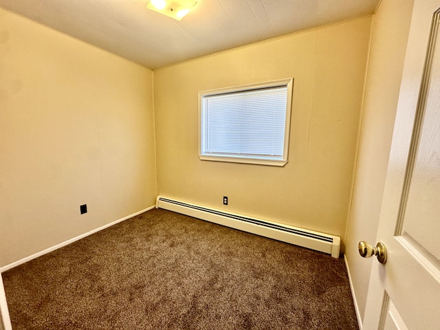 carpeted empty room featuring baseboard heating and baseboards
