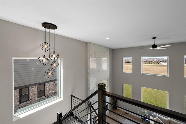 hall featuring recessed lighting and an upstairs landing
