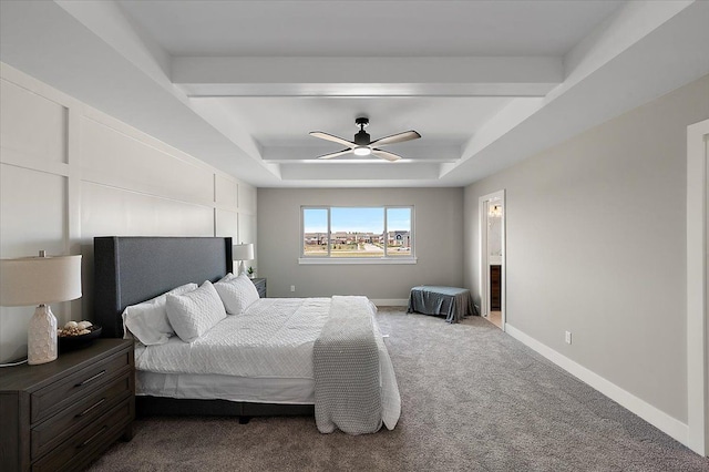 carpeted bedroom featuring a ceiling fan, baseboards, and a raised ceiling