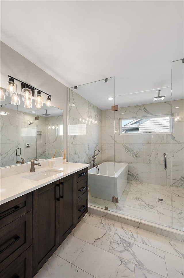 bathroom featuring marble finish floor, a freestanding tub, vanity, and a marble finish shower